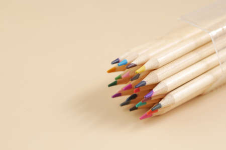 Close up of colorful drawing pencils on light orange backgroundの写真素材