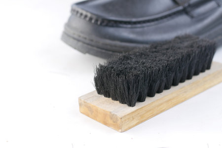 cleaning Shoe with a brush on floor