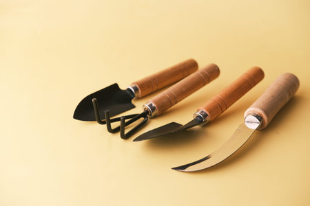 Gardening Gloves and tools on a yellow backgroundの写真素材