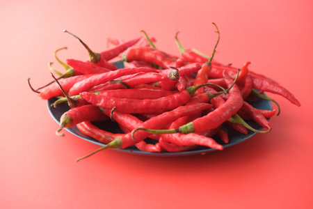 red chili pepper on a plate on red background