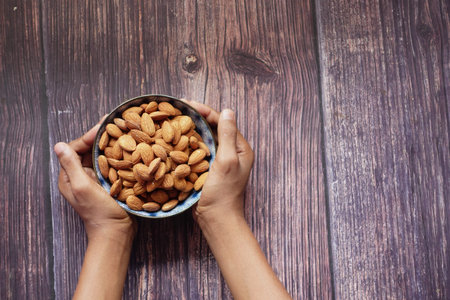 close up of almond nuts on mans handの写真素材