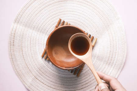soy sauce on a spoon on table top viewの写真素材
