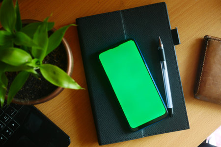 top view of smart phone and notepad on tableの写真素材