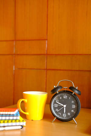 coffee mug, and clock on table close upの写真素材