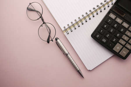 black color calculator and notepad on color backgroundの写真素材