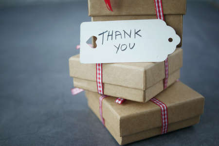 thank you note and gift box on black backgroundの写真素材