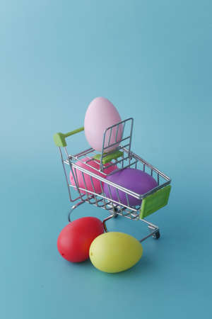 easter concept with multi color egg with a shopping art on color backgroundの写真素材