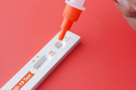 Negative Covid-19 test kit on red backgroundの写真素材