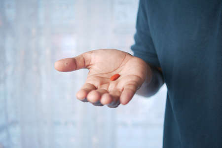 man hand holding pills with copy spaceの写真素材