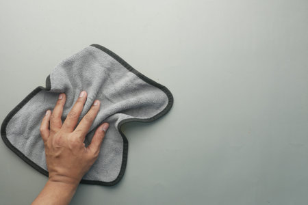 top view of person hand cleaning table with cloth