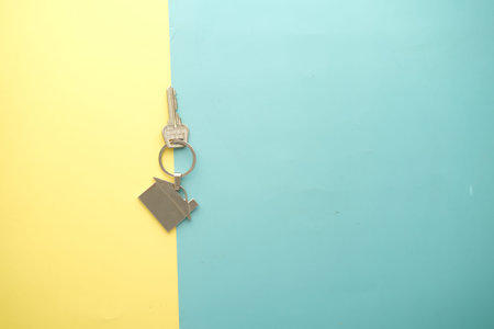home finance concept with key and house symbol on color background