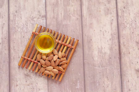 almond oils and fresh nuts on tableの写真素材