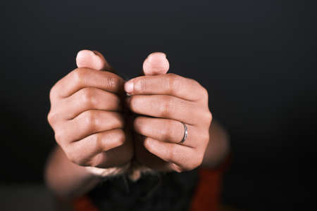hand tied with rope against black backgroundの写真素材