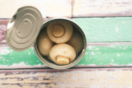 Canned mushrooms in blow on white background