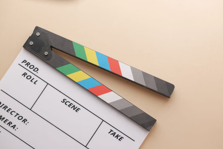 Movie clapper board against light yellow backgroundの写真素材