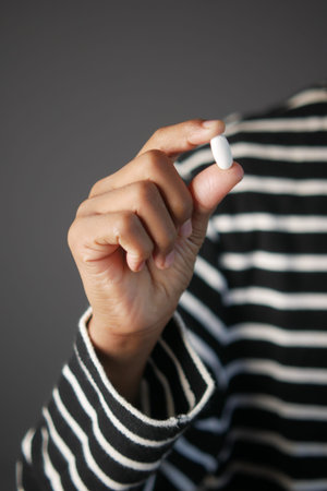 Close up of man hand holding pills with copy space