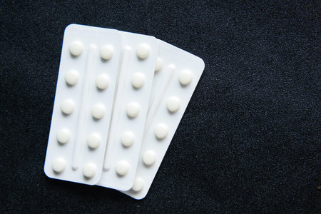 Close up of pills of blister pack on black background