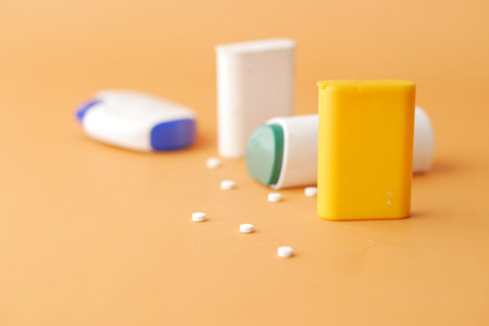 artificial sweetener containers on orange background