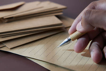 man hand writing on notepad while sitedの写真素材