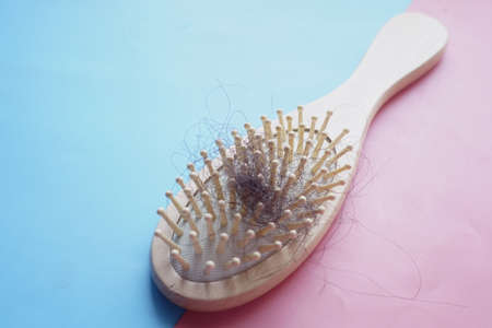 a brush with lost hair on tableの写真素材