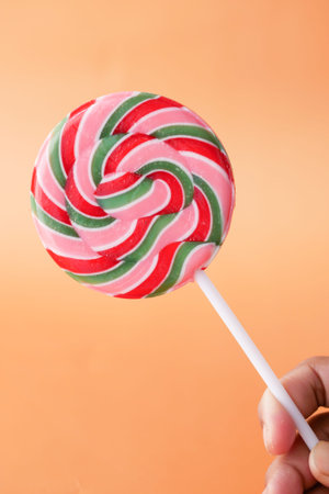 close up of lollipop candy on orange background