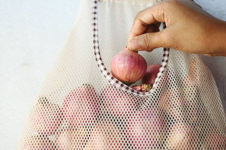 fresh onion in a reusable shopping bag