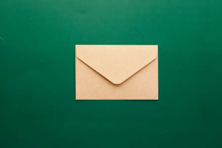 a envelope drops on a green color backgroundの写真素材