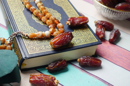 Holy book Quran and rosary on table, close up.の写真素材