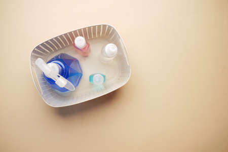 hand sanitizers in a plastic box on color backgroundの写真素材