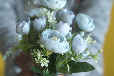 close up of man holding light green color rose flowerの写真素材