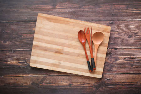 wooden chopping board on black background top downの写真素材