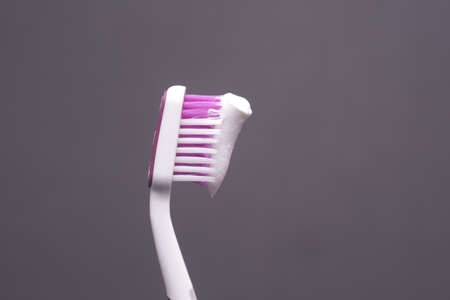 hand holding tooth brush with pasteの写真素材