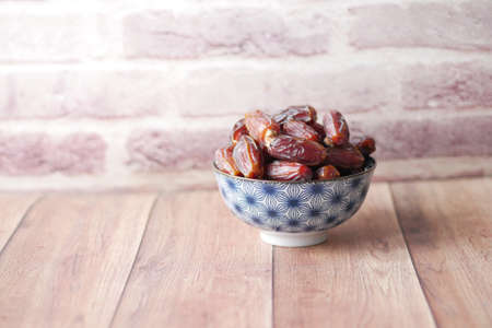close up of fresh date fruit in a bowl on tableの写真素材
