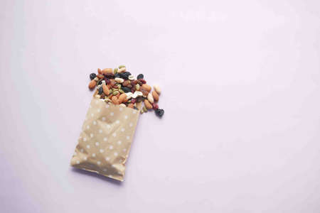 top view of many mixed nuts spilling a from a packetの写真素材