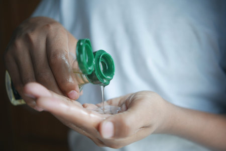 young man pouring hair oil on hand