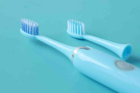 a blue color electronic toothbrushes on blue backgroundの写真素材