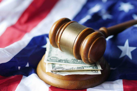 Closeup of gavel and book against american flag
