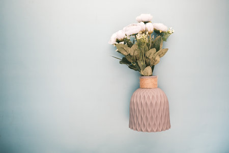 hand holding rose flower against white wallの写真素材