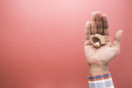 Hearing aid concept, a young man with hearing problems.
