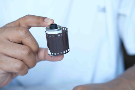 men holding film rolls close up