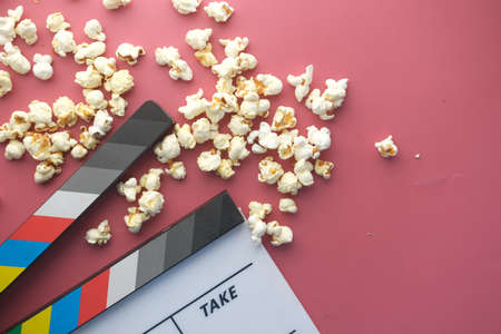 Movie clapper board and popcorn on red backgroundの写真素材