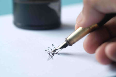 Close up of man hand writing a letter with fountain penの写真素材
