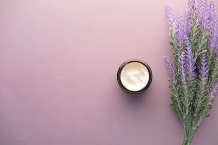 herbal cream cosmetic in a container on purple backgroundの写真素材