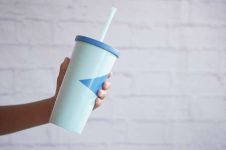 holding a reusable eco coffee cup with copy space.の写真素材