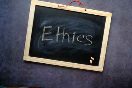 Ethics word on a chalk board on black background ,