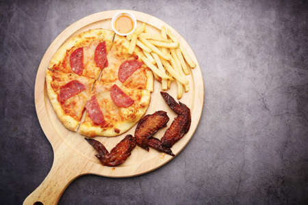 Slice of cheese pizza on a plate on wooden table.の写真素材