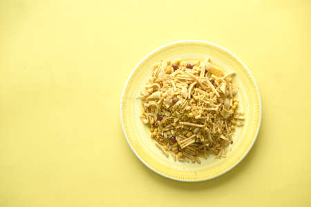 Bombay mix or Chiwda on yellow backgroundの写真素材