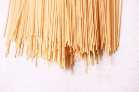 Yellow long spaghetti on white background.の写真素材