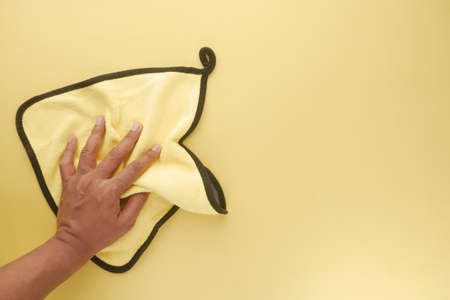 top view of person hand cleaning table with yellow color clothの写真素材