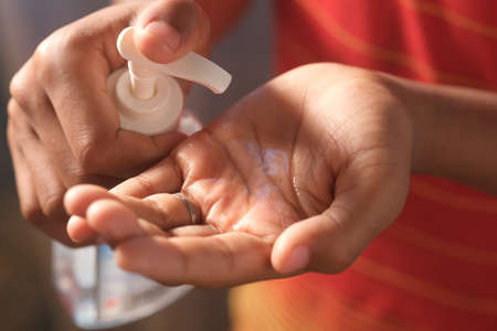 Using sanitizer liquid for preventing corona virusの写真素材